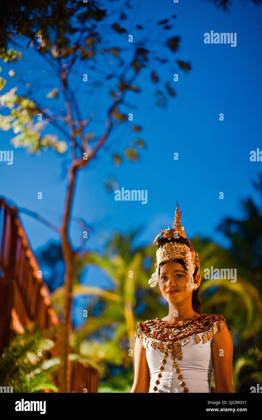 Un giovane ballerino cambogiano di Apsara cammina su un sentiero al crepuscolo. Siem Reap, Cambogia. Un ballerino di Apsara è un ballerino Khmer classico. Foto Stock