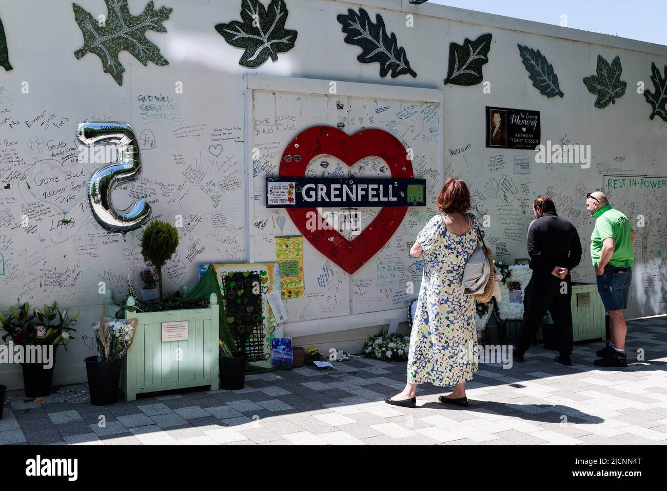 Londra, Regno Unito. 14th giugno 2022. La gente paga i loro rispetti al muro commemorativo della Comunità di Grenfell alla base della torre di Grenfell mentre la comunità dei sopravvissuti, delle famiglie e dei membri del pubblico ha commemorato il quinto anniversario del fuoco della torre di Grenfell in cui 72 persone hanno perso la vita. Credit: Wiktor Szymanowicz/Alamy Live News Foto Stock