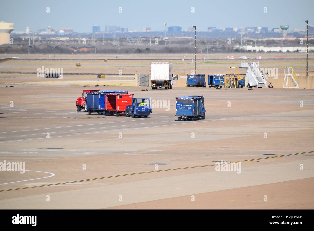 Gli agenti del servizio di rampa di American Airlines prelevano i bagagli all'aeroporto DFW Foto Stock