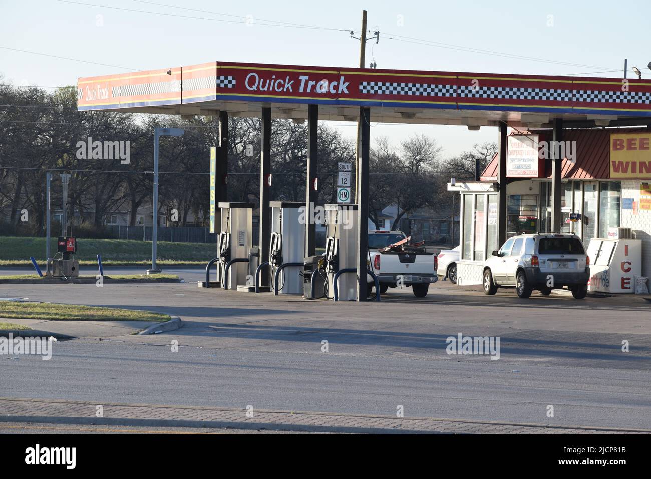 Pick up camion parcheggiato presso le pompe di gas di una stazione di gas Quick Track Foto Stock