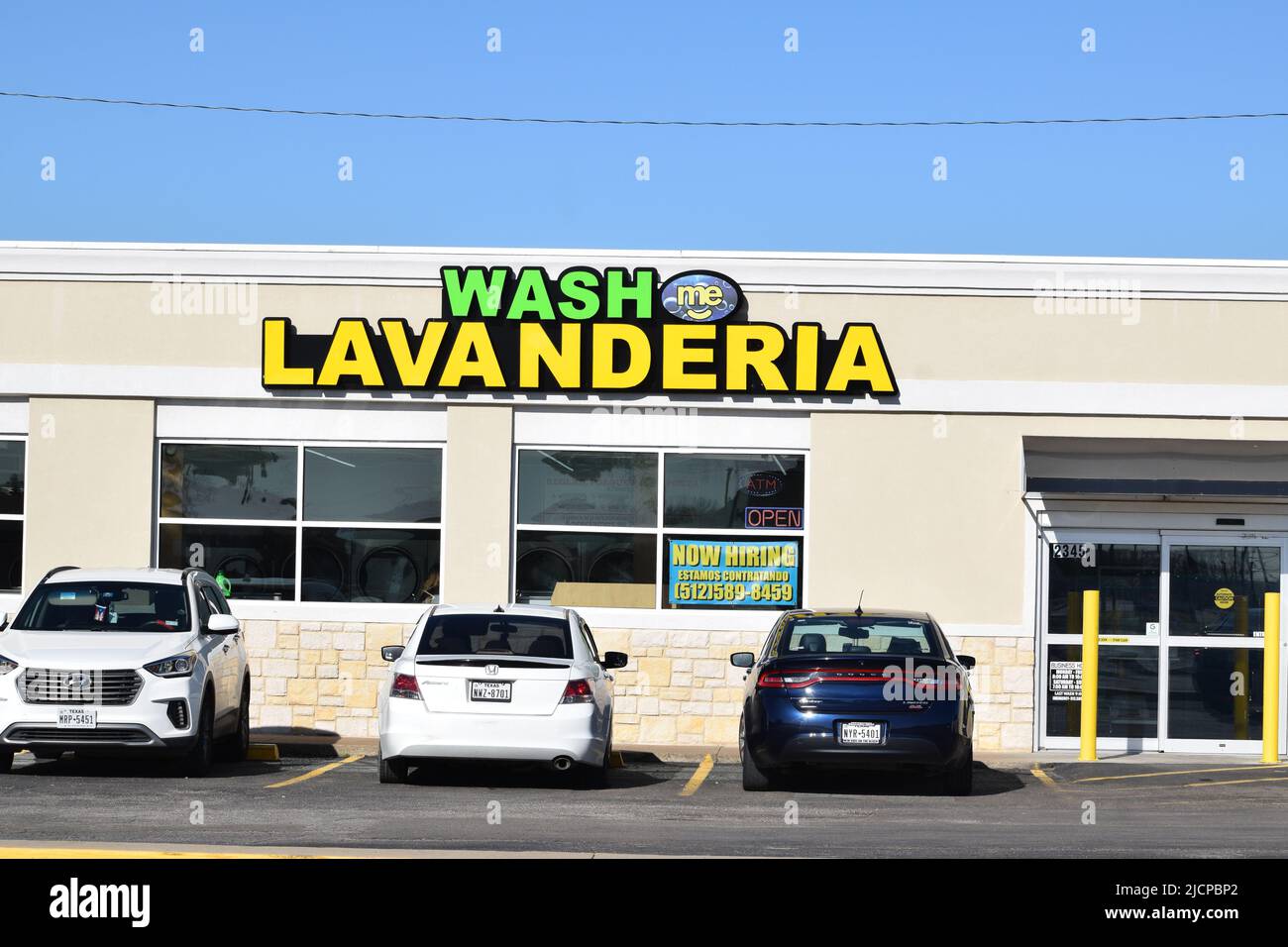 Auto parcheggiate di fronte alla lavanderia Wash Me (lavanderia automatica) Foto Stock