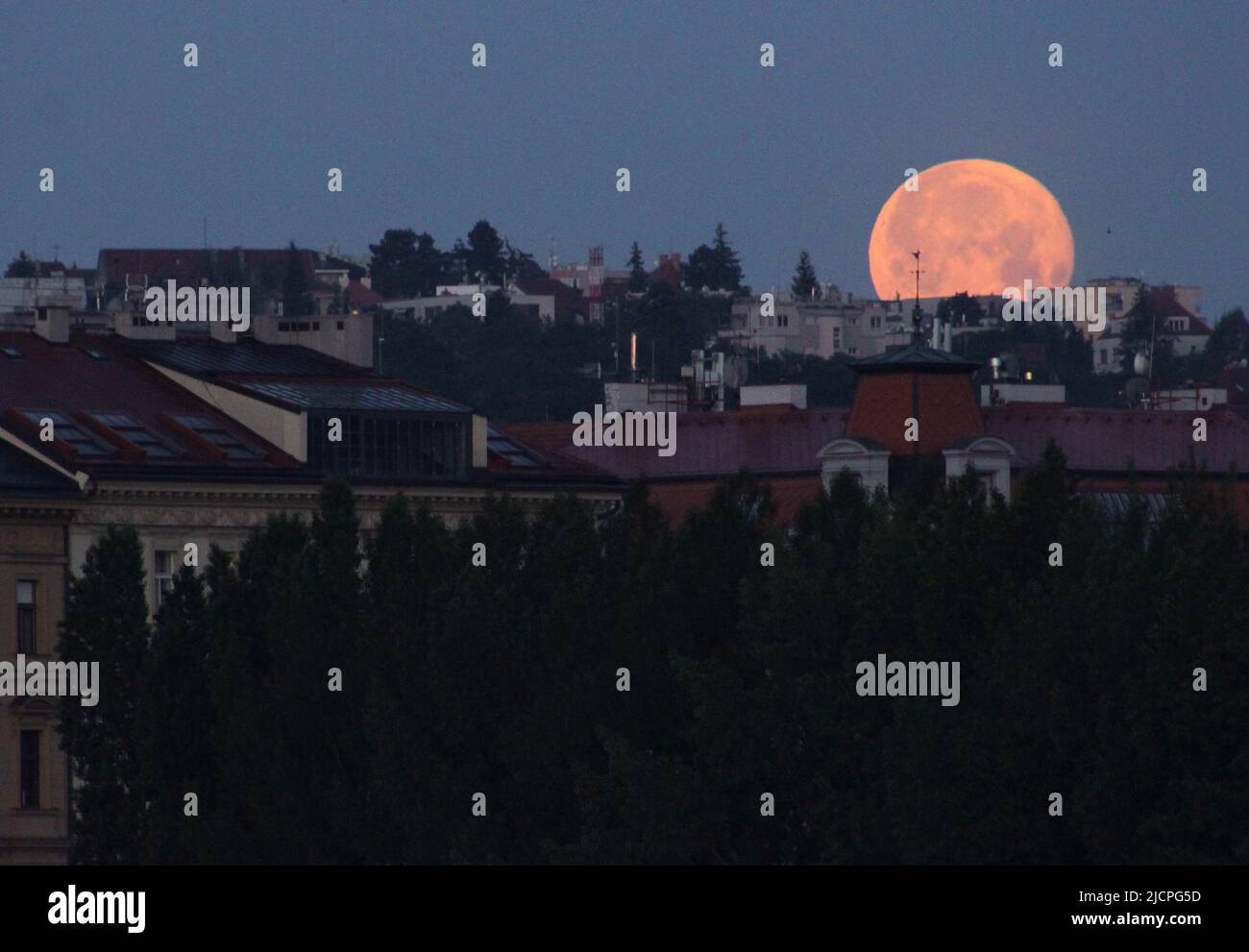 Una luna piena sorge dietro Praga, Repubblica Ceca, 14 giugno 2022. La luna ha raggiunto il suo palcoscenico completo martedì, durante un fenomeno noto come supermoon Foto Stock