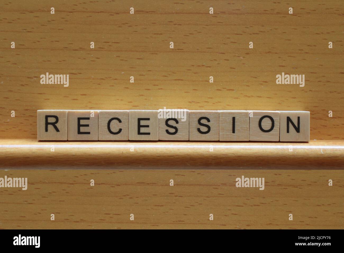 Concetto di recessione, la parola recessione in blocchi di legno su uno sfondo di legno con spazio copia Foto Stock