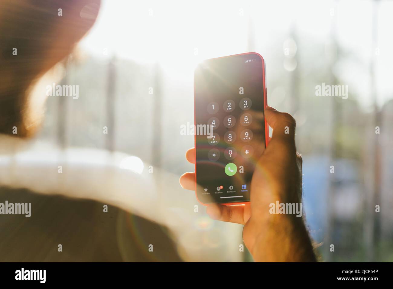 Persona che cerca un numero tra i suoi contatti telefonici. Chiamate ai client. Giovane uomo che registra un numero sul suo cellulare Foto Stock