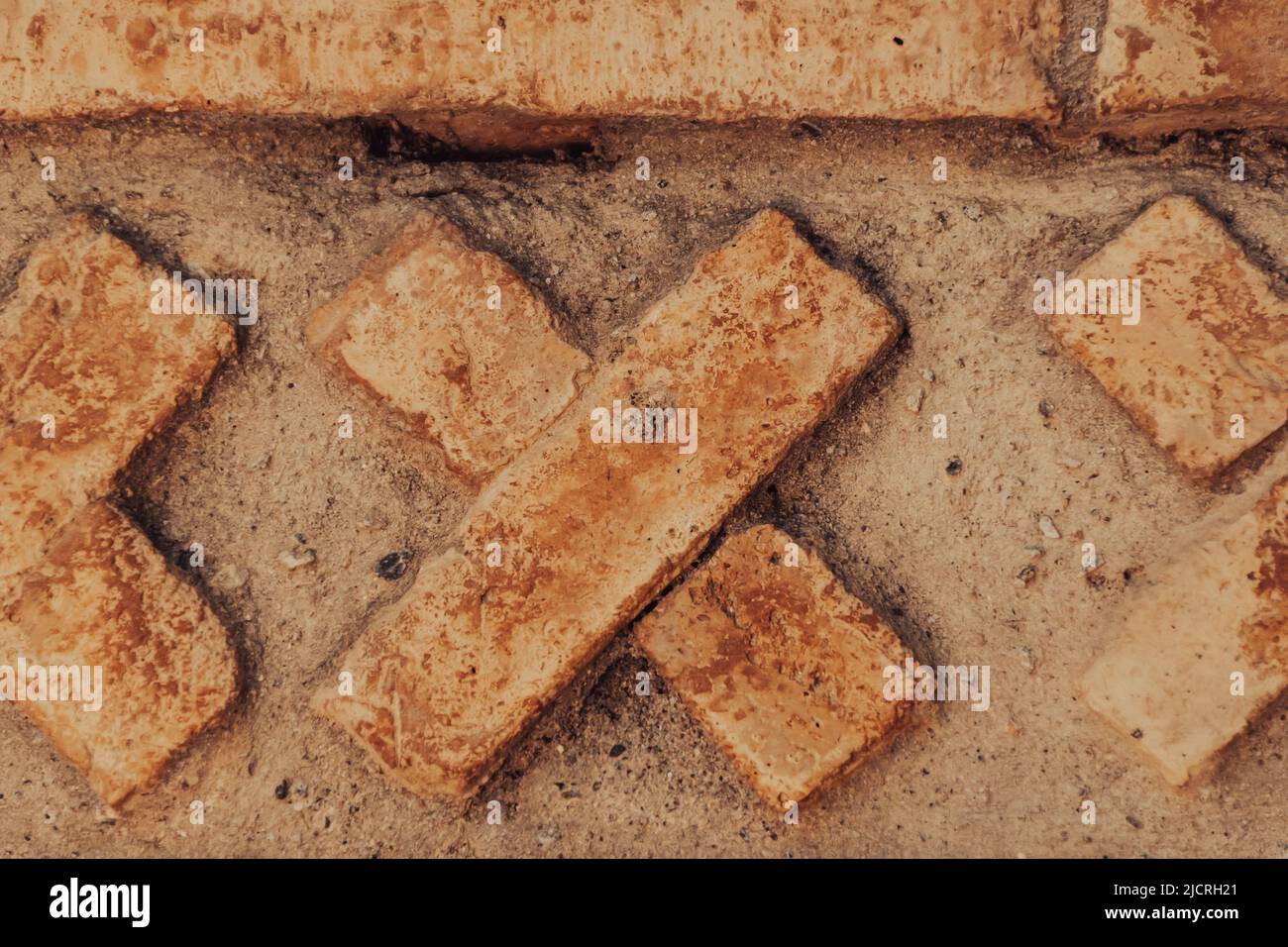 Una croce di mattoni costruita come parte di un disegno di parete a Marrakesh, Morroco. Foto Stock