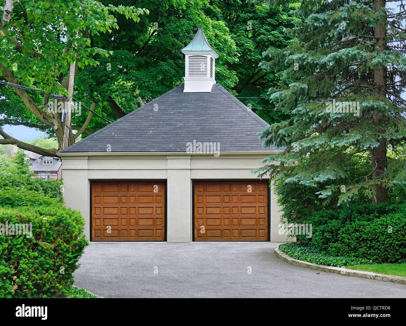 Garage residenziale indipendente circondato da alberi Foto Stock