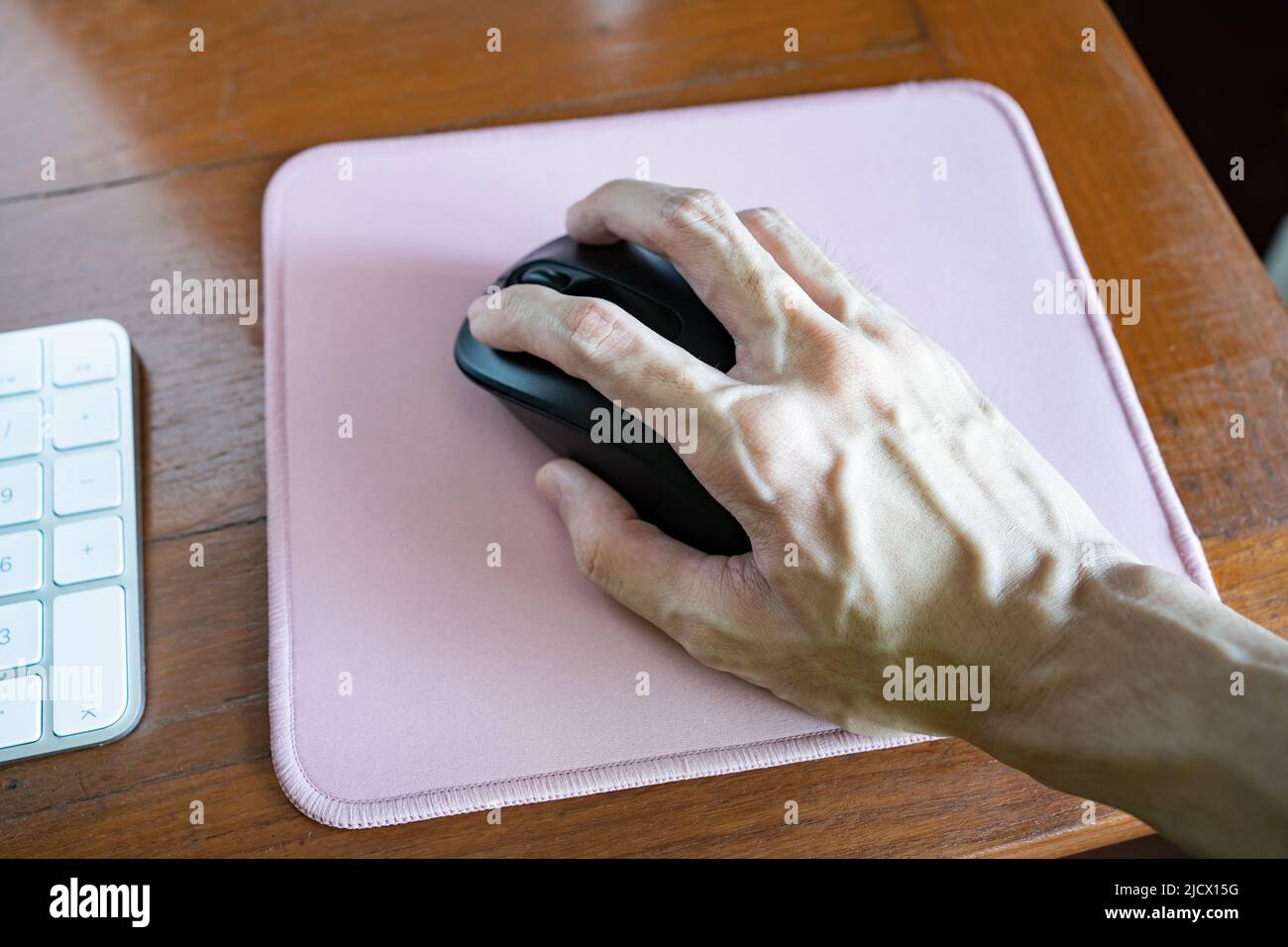 Utilizzo del mouse wireless su un tappetino del mouse Foto Stock