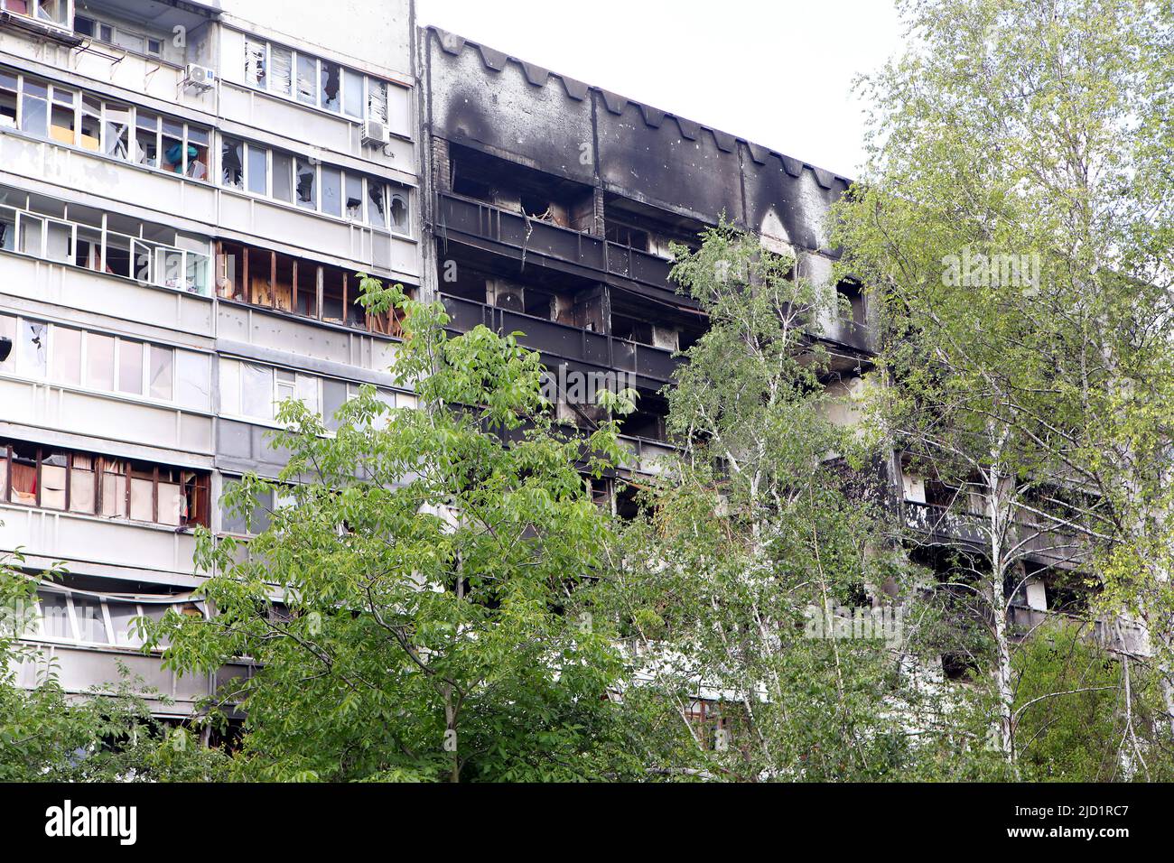 KHARKIV, UCRAINA - 16 GIUGNO 2022 - Un blocco di appartamenti prefabbricato coperto di fuliggine si trova a Pivnichna Saltivka, un quartiere che ha sostenuto il più da Foto Stock