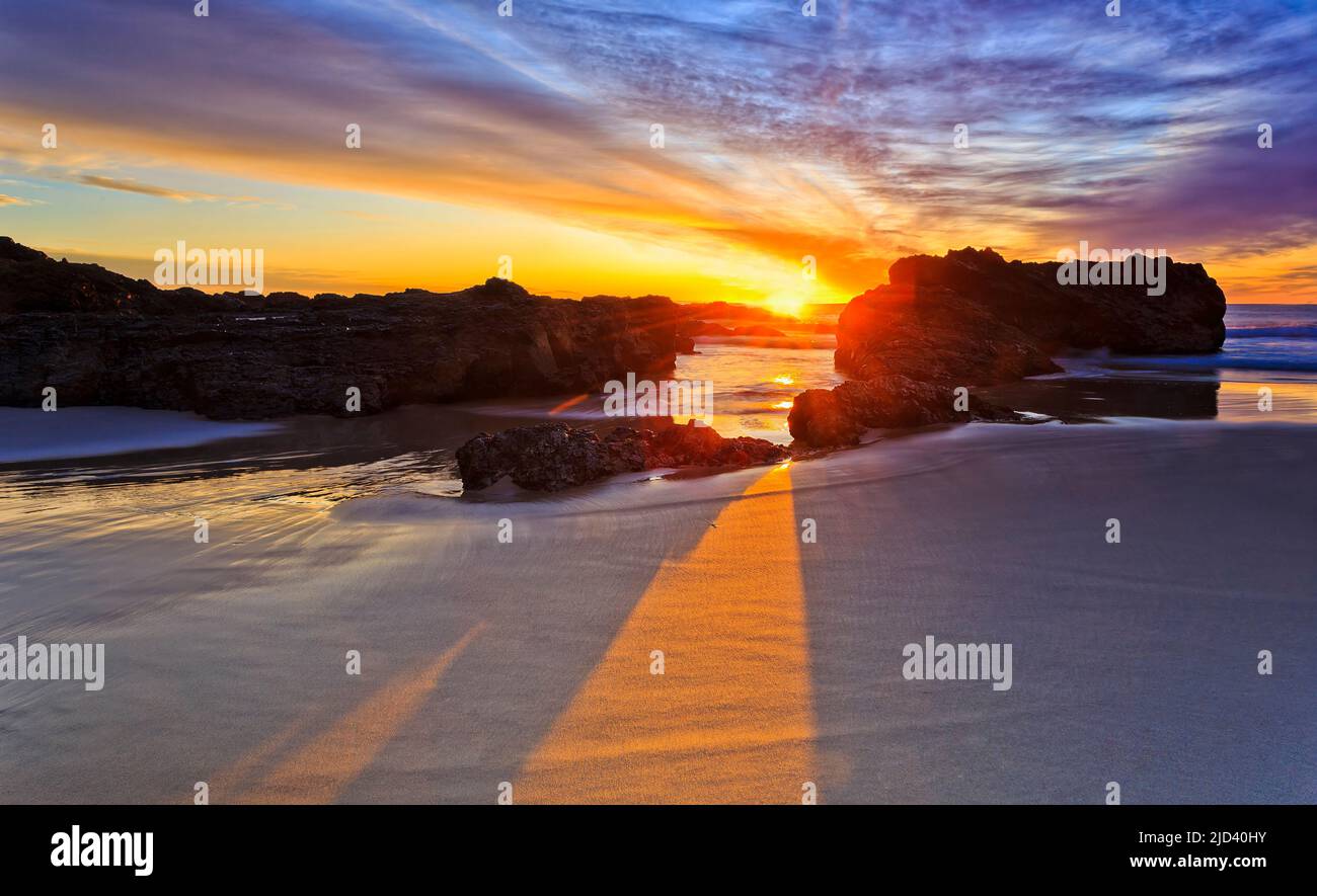 Sfumature sceniche dal sole che sorge e rocce di arenaria erose alla spiaggia di Burgess della città di Forster sulla costa del pacifico Australiano. Foto Stock