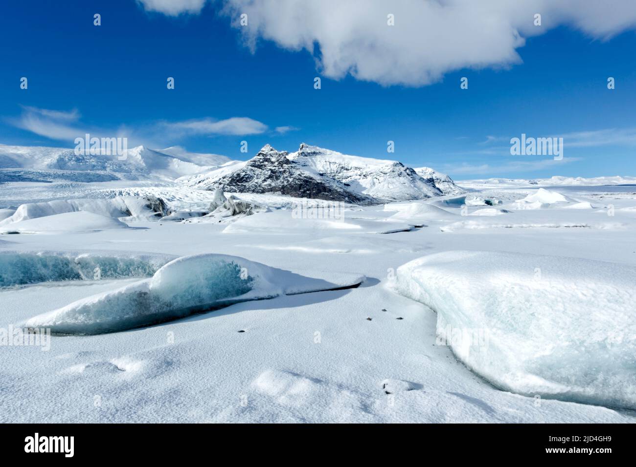 Fjallsarlon, una piccola e bella laguna ghiacciata situata nel Parco Nazionale di Vatnajokull in una luminosa e soleggiata giornata invernale con cielo blu Foto Stock
