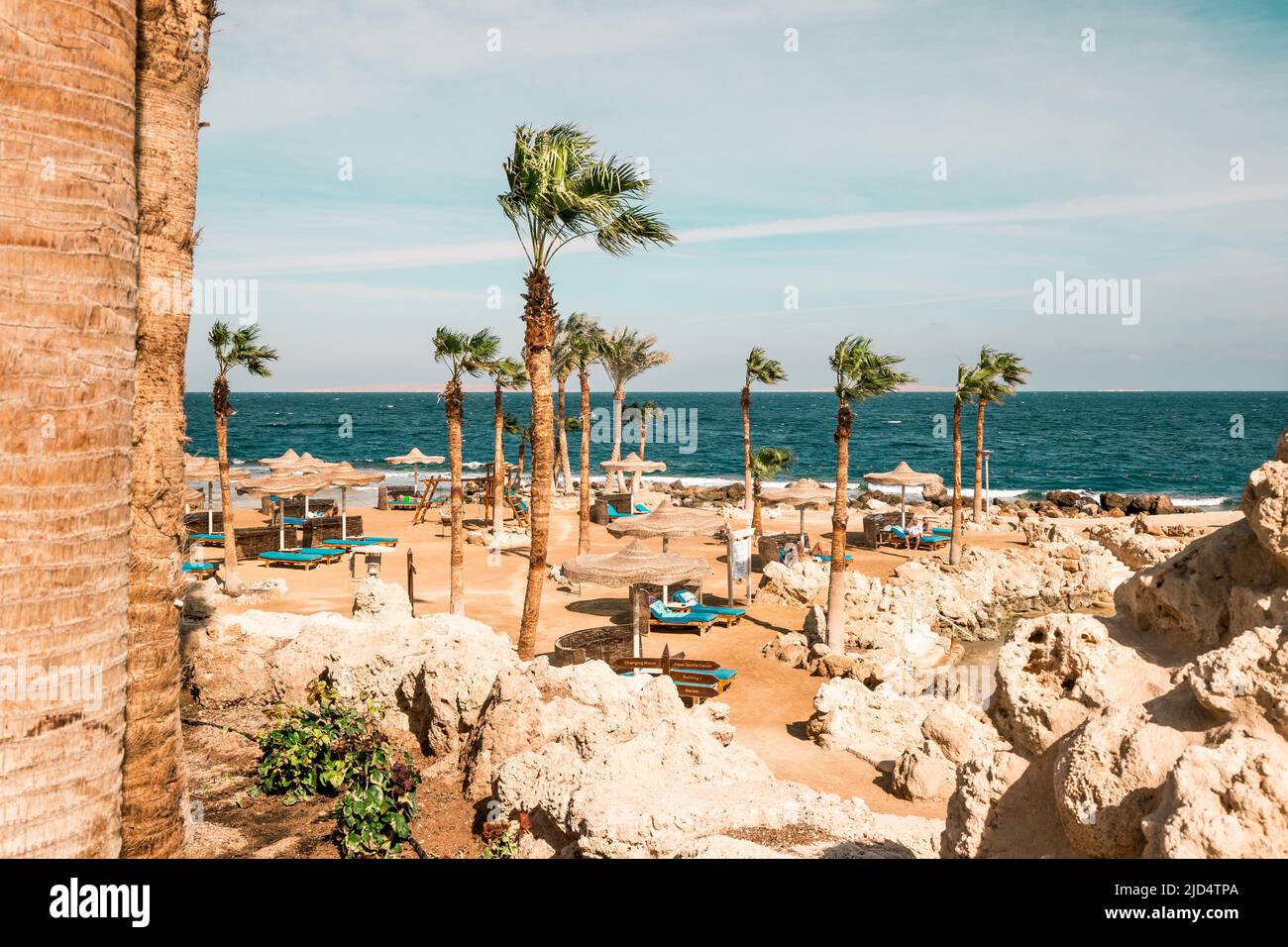 Vista sull'oceano del resort vuoto di Hurghada Egitto con lettini sulla spiaggia e palme Foto Stock