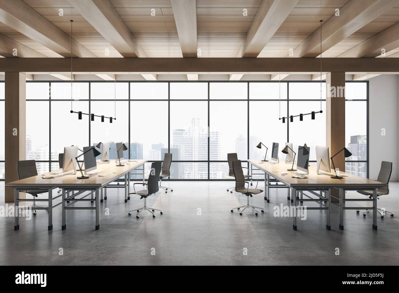 Vista frontale su eleganti file di spazio da lavoro con computer moderni su pavimento in cemento in uno spazioso ufficio con soffitto in legno e vista della città da enorme Foto Stock