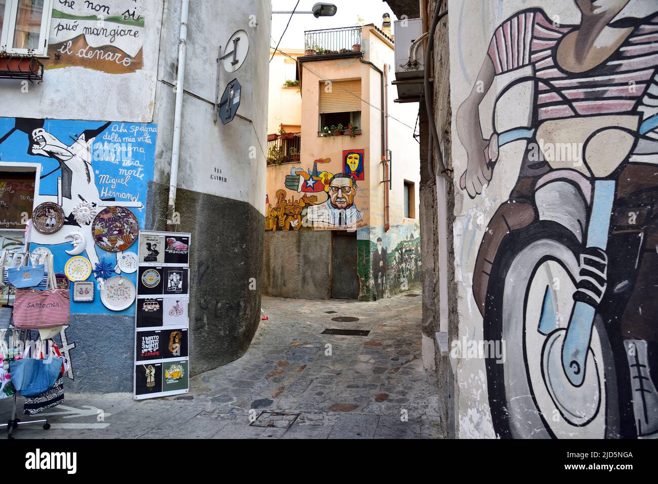 ORGOSOLO, SARDEGNA, ITALIA, 21 AGOSTO 2019: Strada stretta nel centro storico di Orgosolo decorata da pitture murali di artisti locali, in Sardegna, Italia Foto Stock