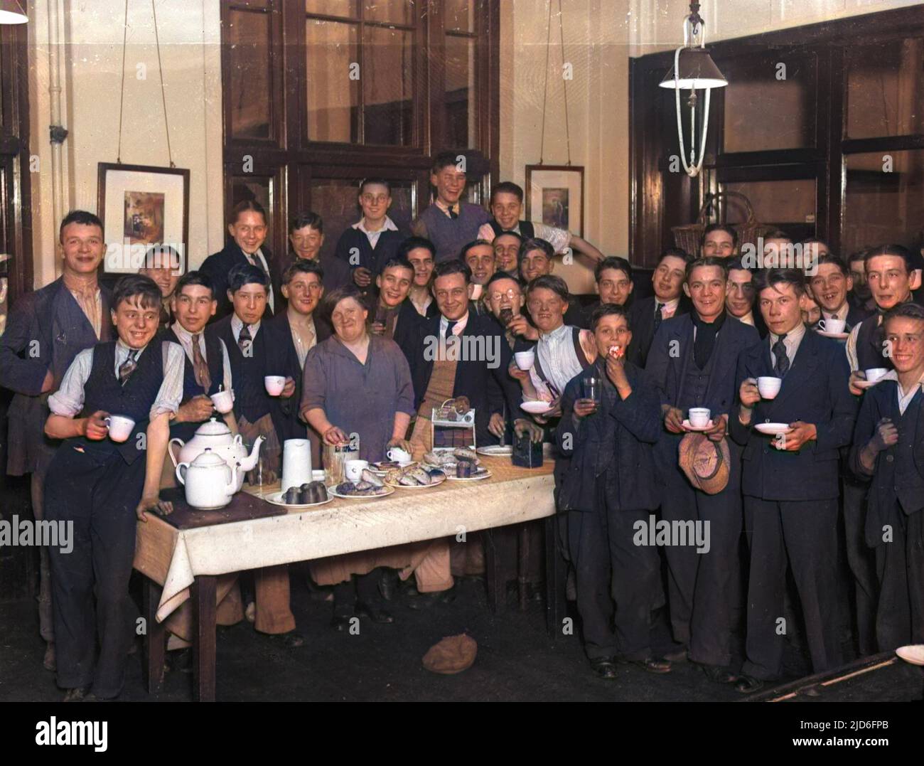 Una jolly foto di gruppo di una classe di ragazzi, con il loro insegnante, alla London County Council School of Cookery for Boys. Versione colorata di : 10167138 Data: 1930s Foto Stock