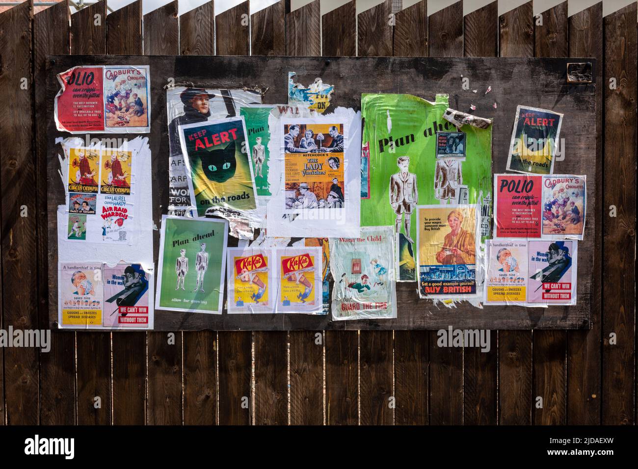 Vecchi poster vintage su una recinzione in legno, UK 2022 Foto Stock