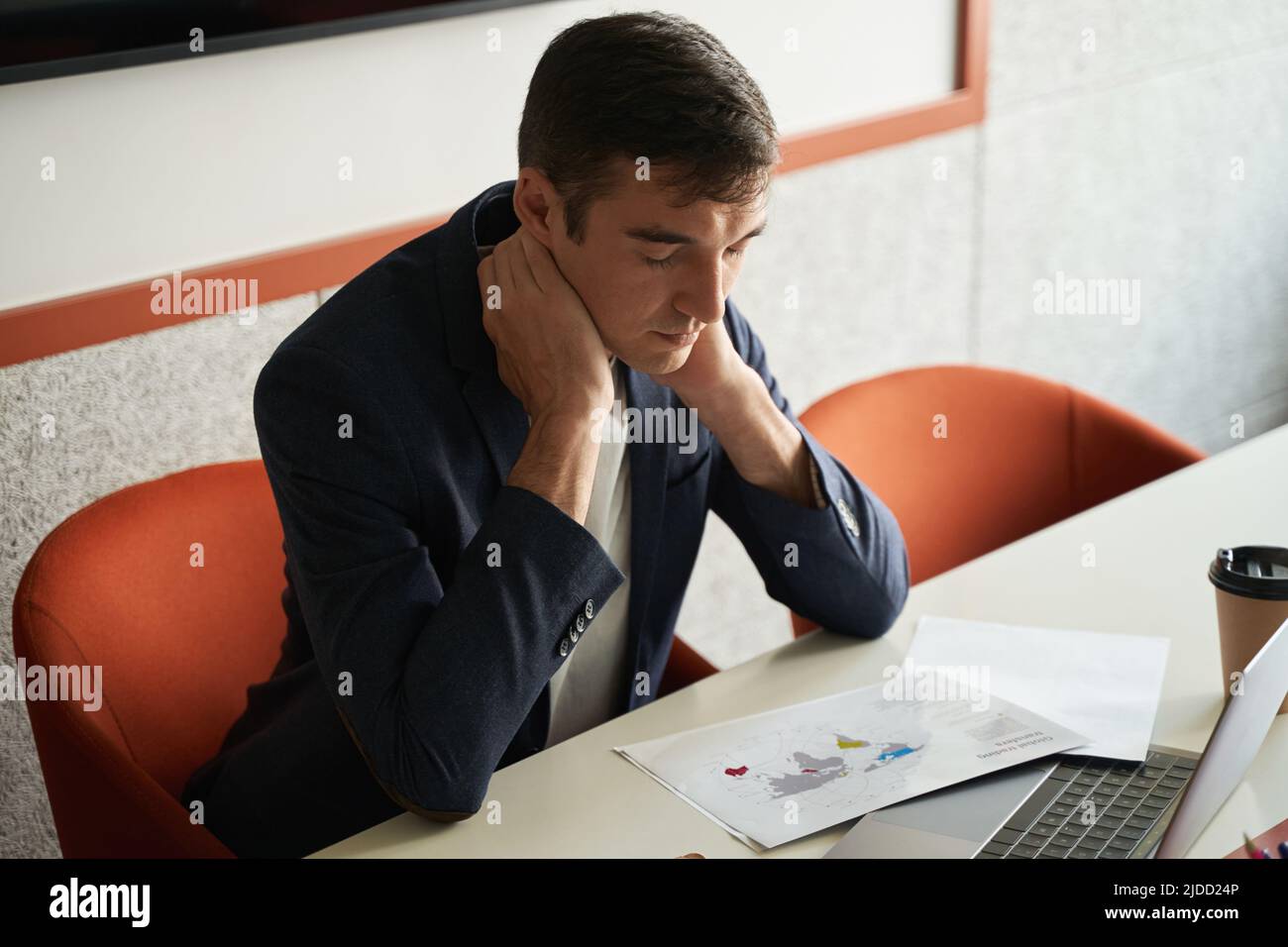 Il lavoratore del collare bianco infastidito sfrega il collo sul posto di lavoro Foto Stock