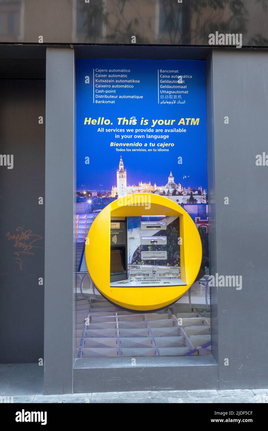 Cash Point multilingue CaixaBank ATM a Siviglia Spagna Banca spagnola Caixa Foto Stock