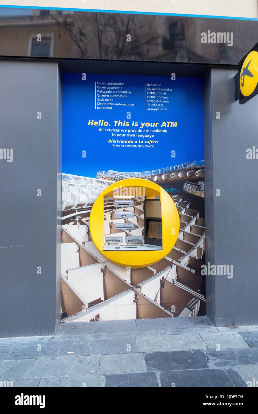 Cash Point multilingue CaixaBank ATM a Siviglia, Spagna Foto Stock