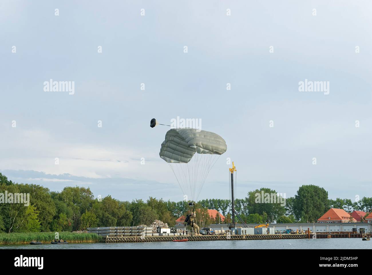 Un soldato paracadutato scende sull'acqua. Foto scattata durante lo spettacolo di paracadute jumping durante il Commando Fest di Dziwnów - Agosto 2020. Foto Stock