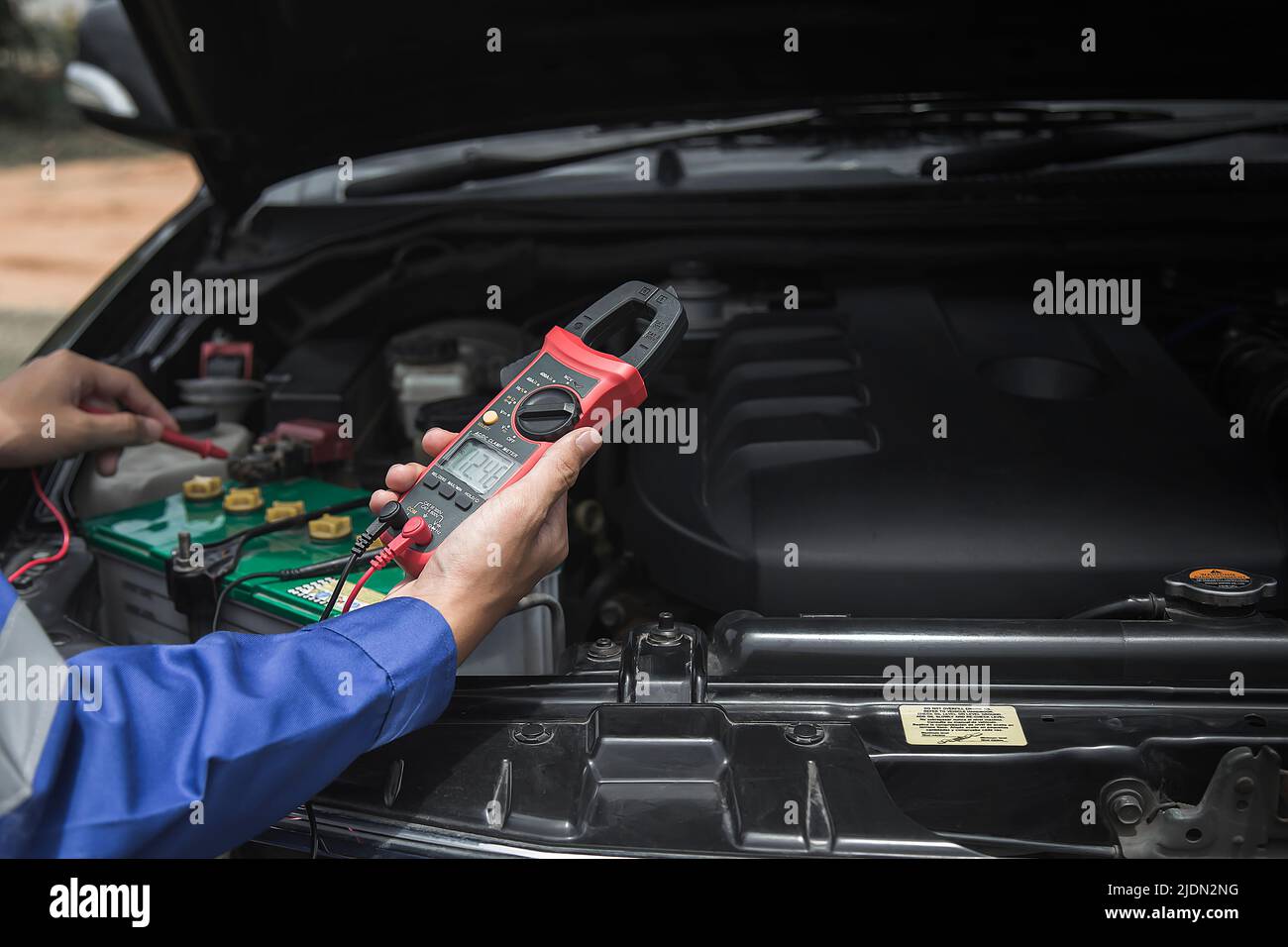 Un tecnico sta controllando la disponibilità della batteria del veicolo. Foto Stock