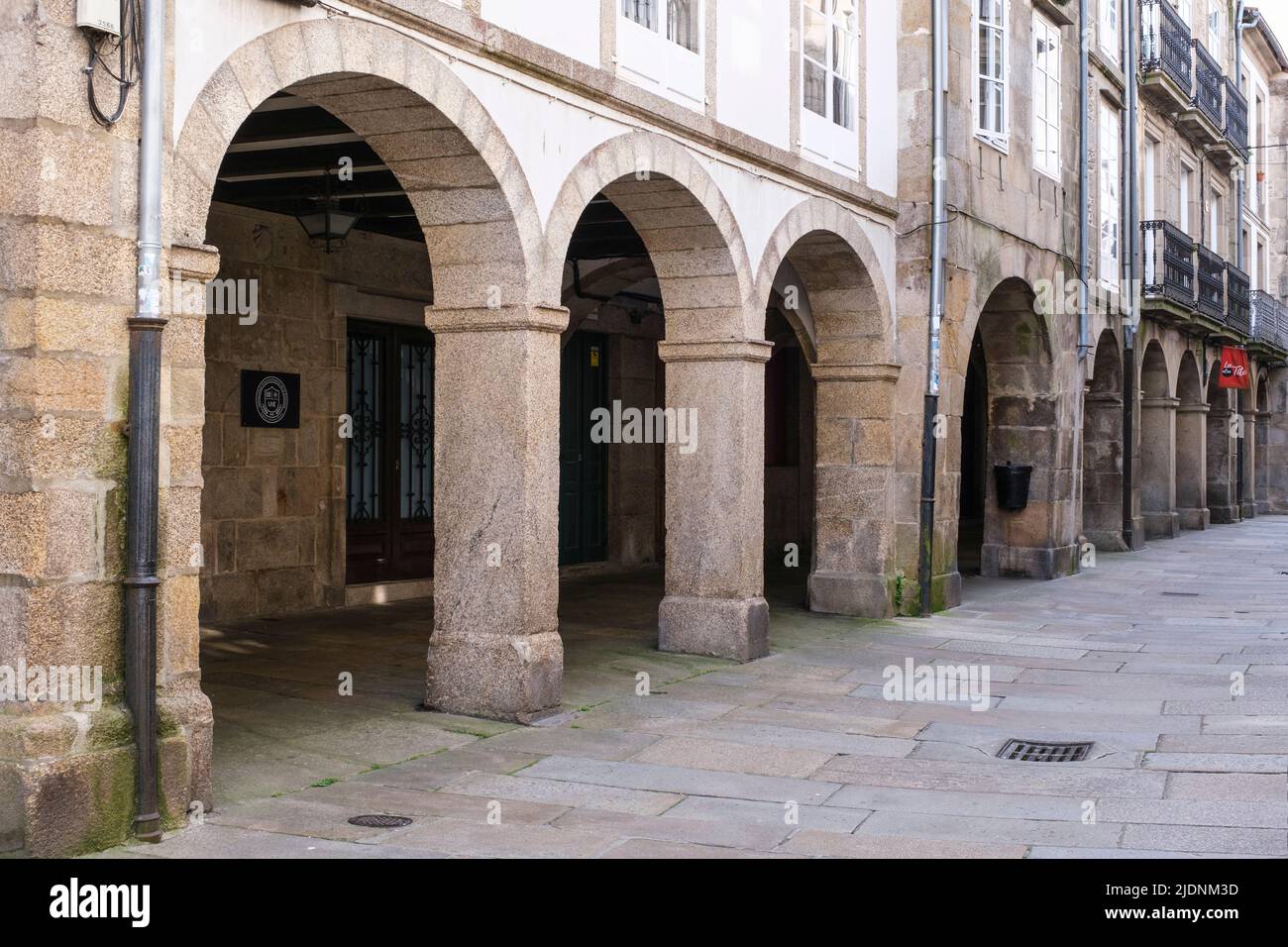 Spagna, Santiago de Compostela, Galizia. Scena stradale. A causa della pioggia frequente molte strade hanno coperto passaggi pedonali. Foto Stock