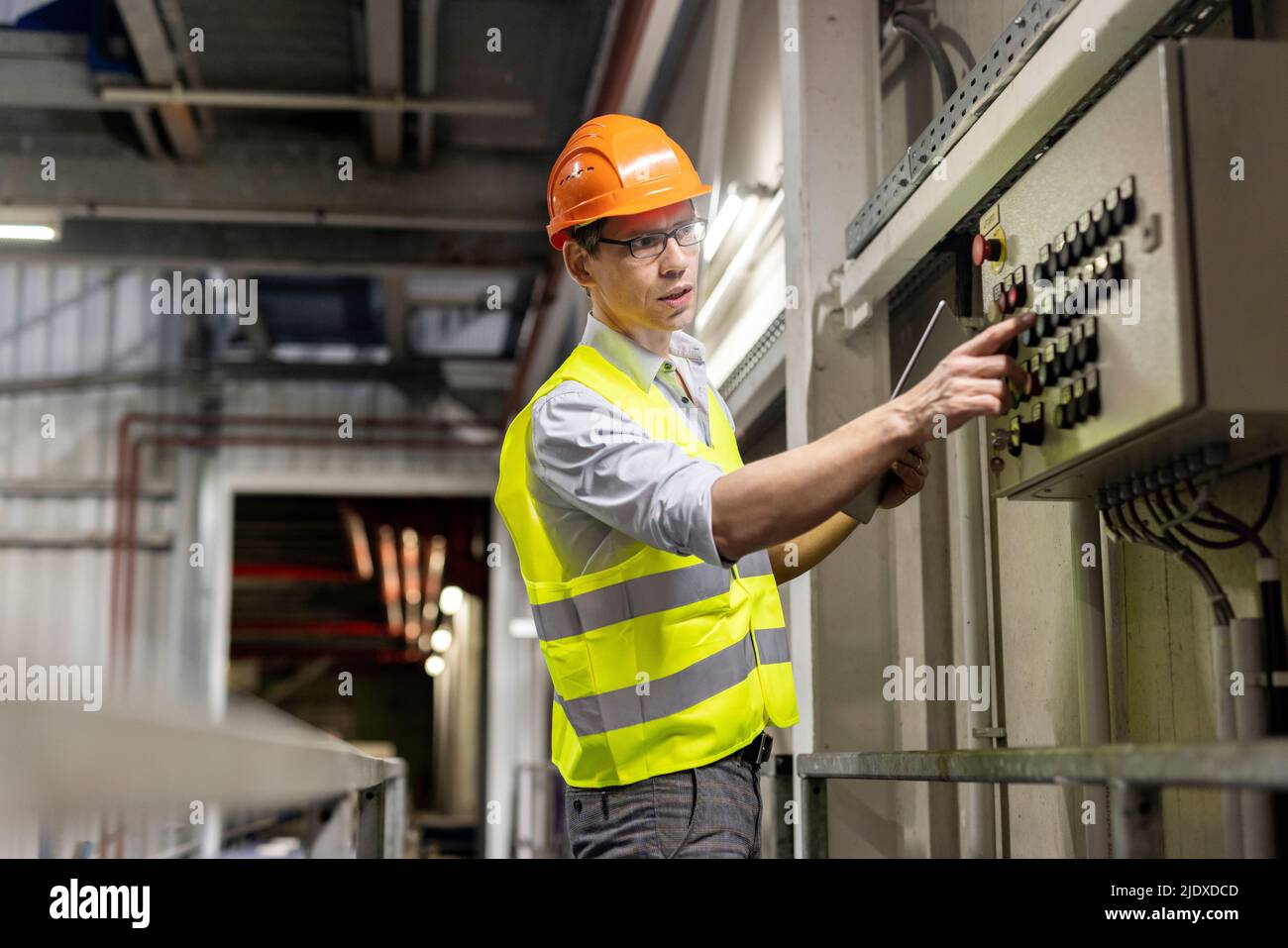 Lavorare con un tablet PC premendo il pulsante del pannello di controllo nel settore Foto Stock