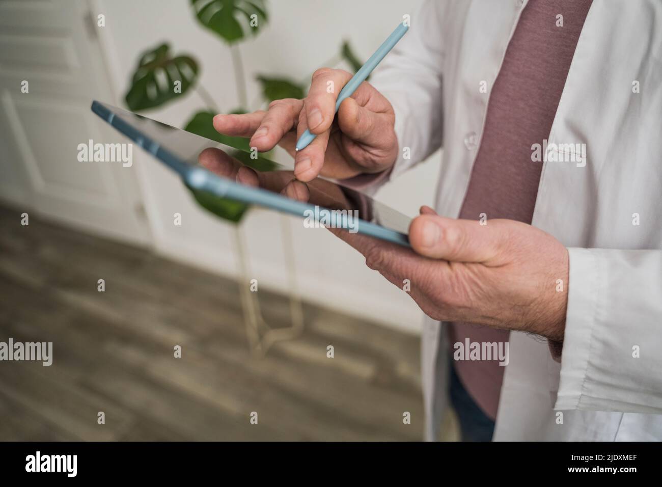 Medico che utilizza un tablet PC e una penna digitalizzata Foto Stock