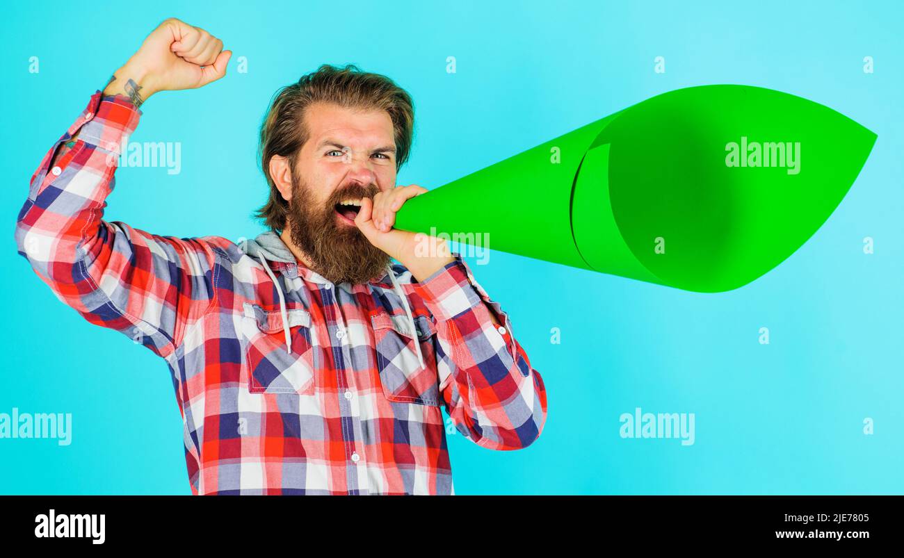L'uomo bearded urla in megafono o altoparlante. Annuncio o diffusione di notizie. Protesta. Propria opinione. Foto Stock