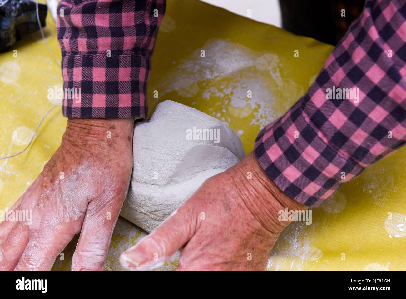 Le mani femminili che fanno l'arte e la ceramica in una classe di officina per le persone mature Foto Stock