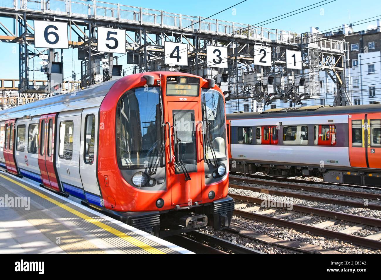 Prima linea Hammersmith treno della metropolitana di Londra alla stazione di Royal Oak treno passeggeri sotto il portale di segnalazione in avvicinamento alla stazione di Paddington Inghilterra UK Foto Stock