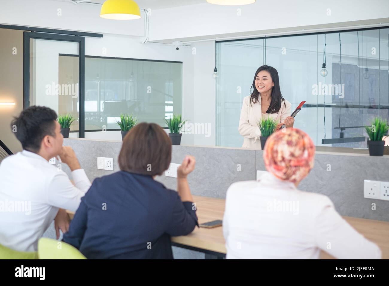 Formazione del team aziendale con il formatore che informa i partecipanti e i partecipanti in un ufficio di co-lavoro. Foto Stock