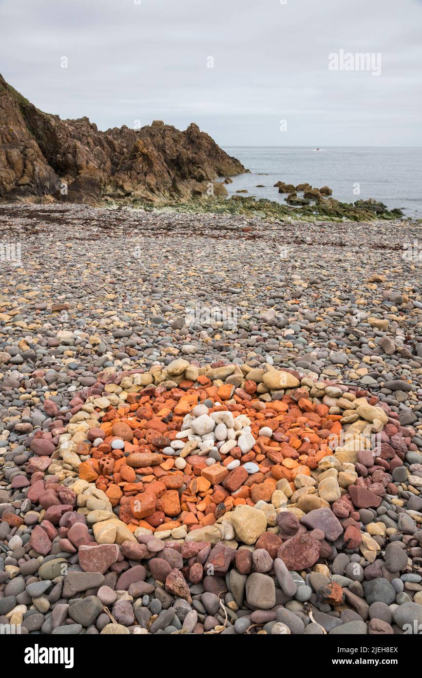 Rocce colorate disposte in un modello circolare sulla spiaggia, vicino a Eyemouth, Berwickshire, Scozia Foto Stock