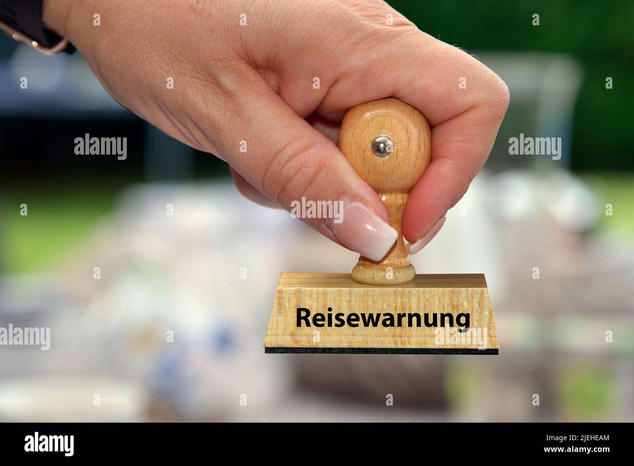 Hand mit Stempel, Frauenhand, Aufschrift: Reisewarnung, Foto Stock