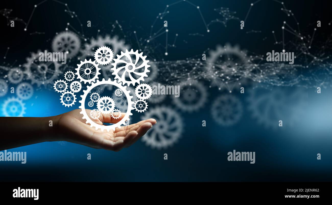Ruote dentate con supporto manuale. Collegamento della luce a reticolo e sfondo del punto di convergenza del circuito. Idea di impresa, lavoro di squadra, strategia di planing, cooperazione. Foto Stock