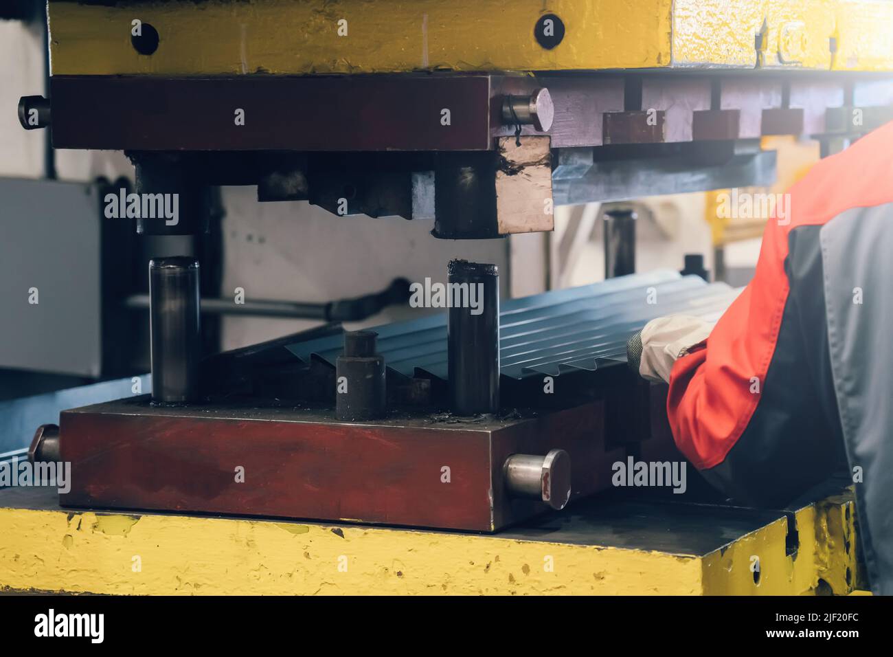 Processo di formatura della lamiera su pressa in fabbrica. Foto Stock