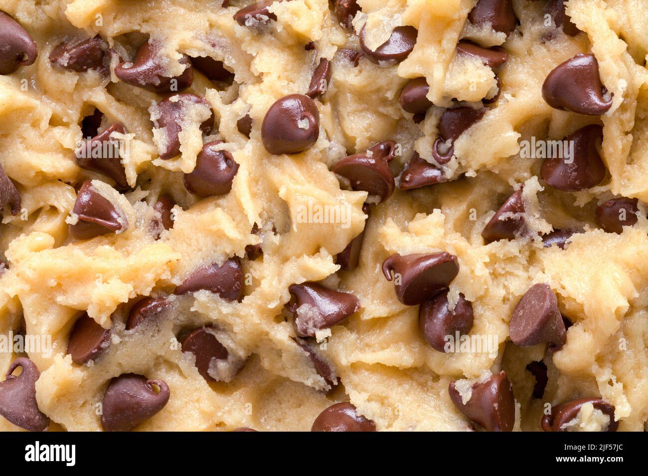 Cioccolato chip cookie impasto sfondo primo piano. Foto Stock