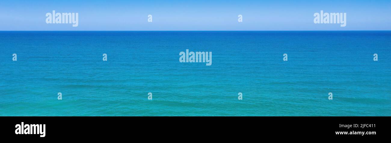 Minimo sfondo panoramico marino. Cielo limpido, orizzonte su onde blu Foto Stock