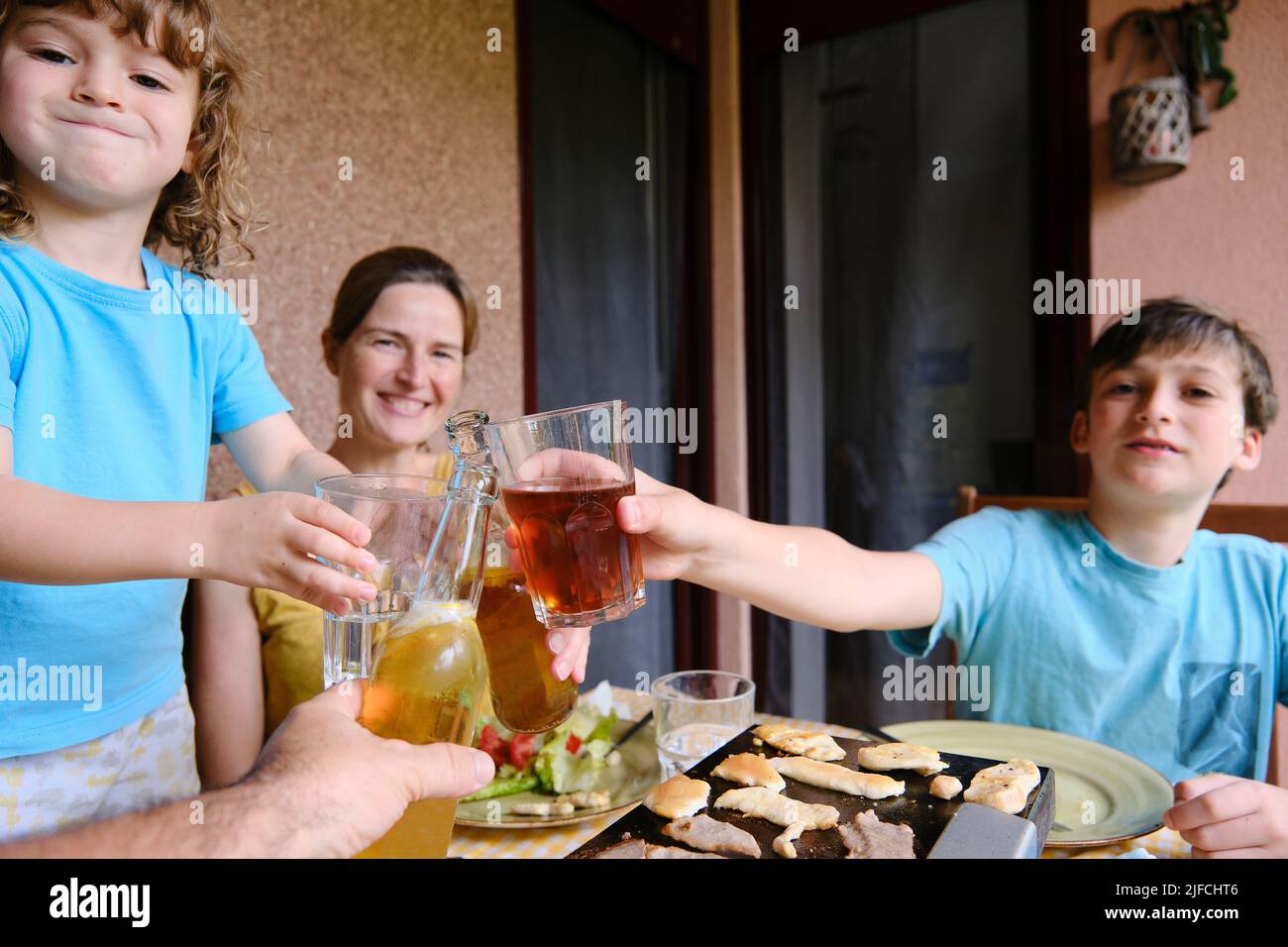 Buona famiglia tostatura sulla terrazza della loro casa Foto Stock