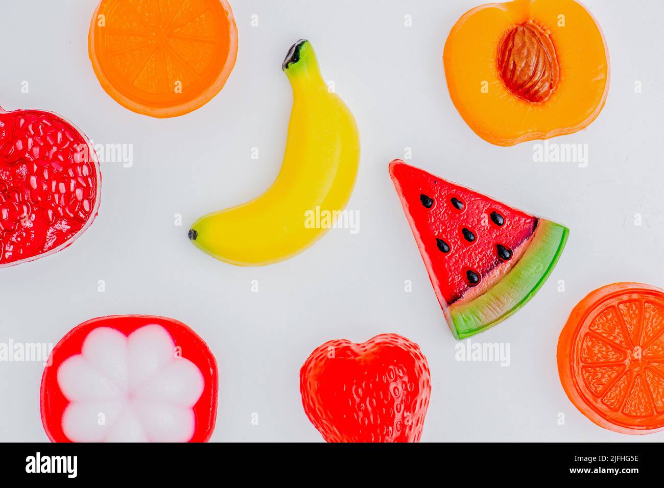 Piatto di pezzi di sapone a forma di e colorato come frutta e bacche. Foto Stock