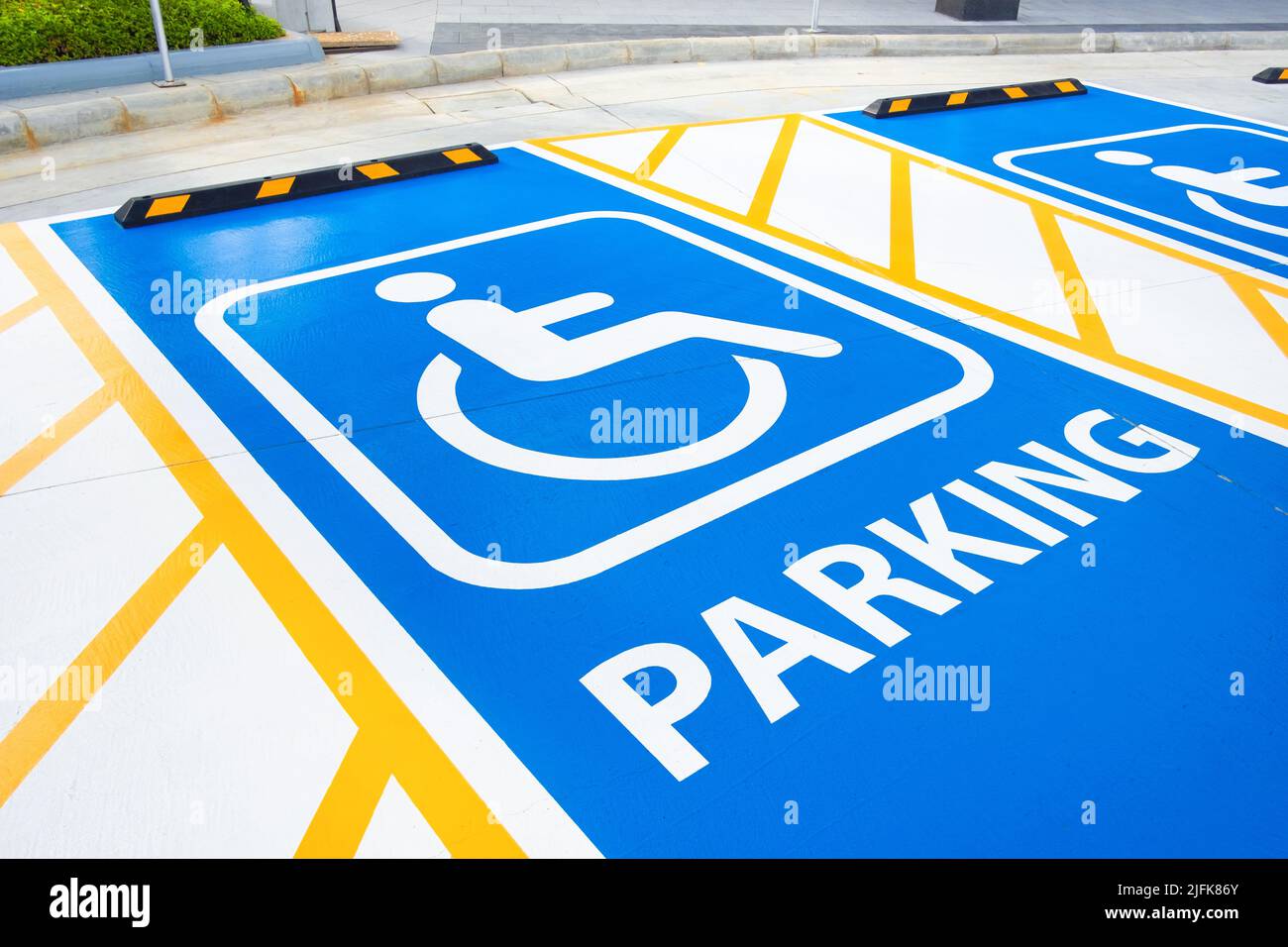 primo piano: cartello per disabili dipinto sul pavimento del parcheggio. parcheggio per disabili, permesso per disabili. Foto Stock
