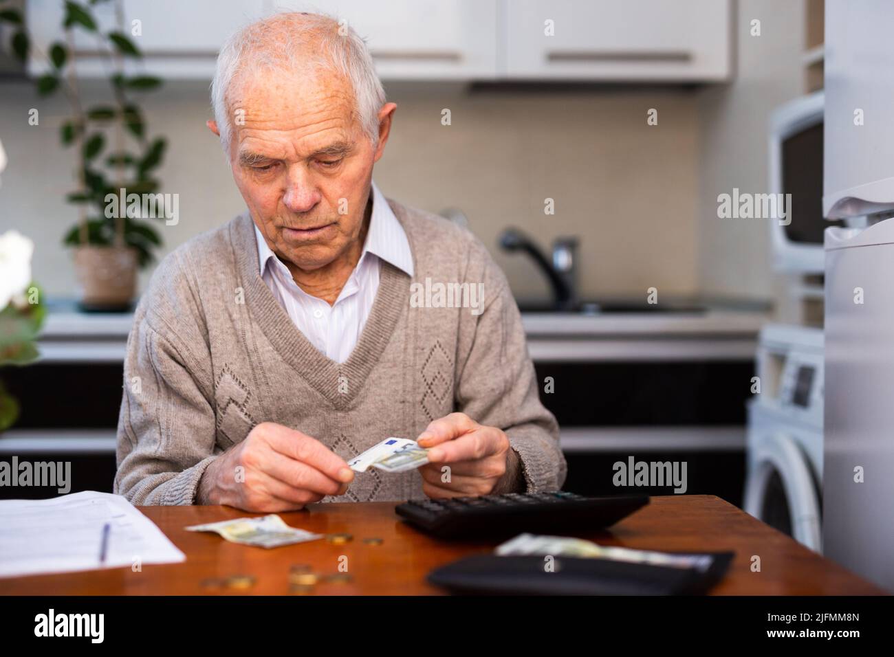 vecchio pensionato disperato che conta i suoi ultimi soldi Foto Stock