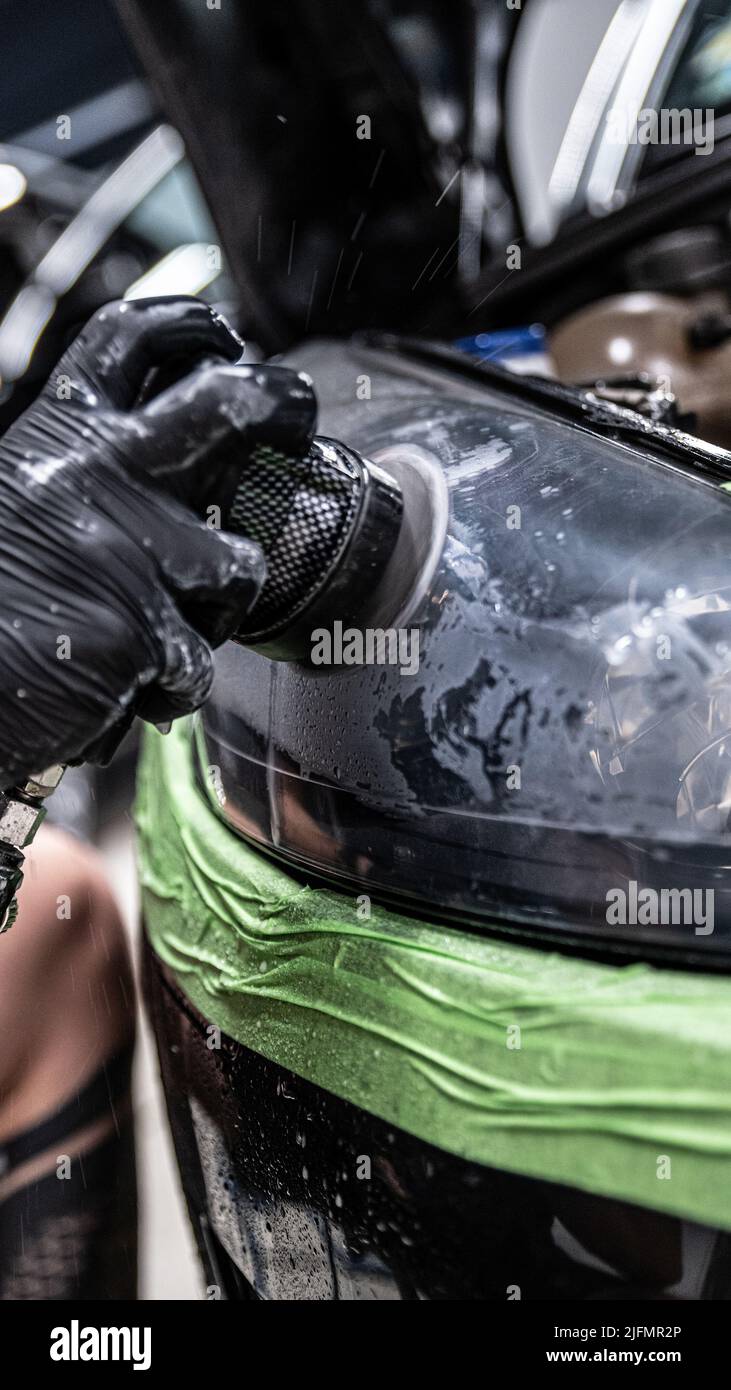 Lucidatura e ripristino dei fari per auto. Foto Stock