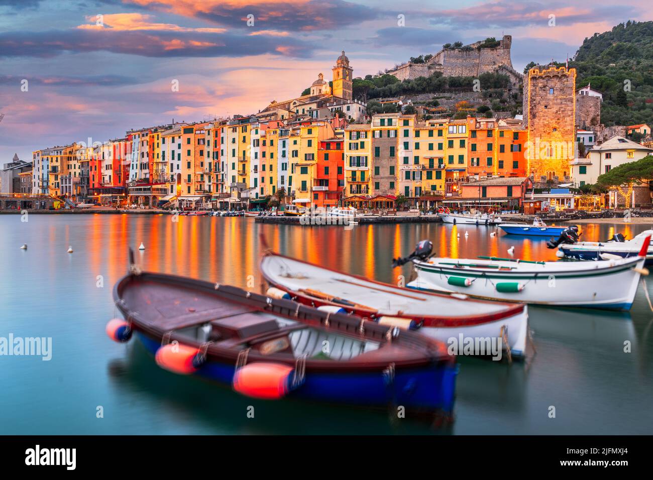 Porto Venere, la Spezia, Italia storico skyline della città con luci di Natale al tramonto. Foto Stock