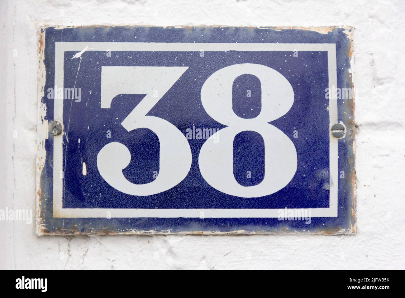 Numero 38 (trentotto) in bianco su una piastra di metallo blu Foto Stock