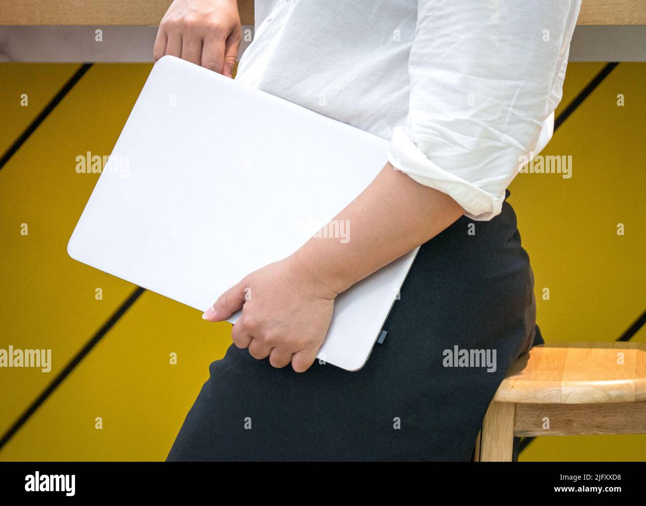 Donna d'affari che porta con sé un notebook. Vista ravvicinata. Foto Stock