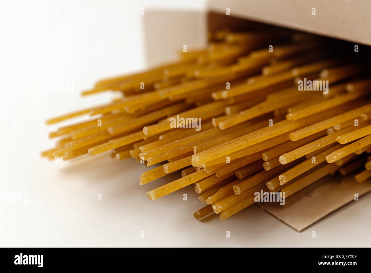 Spaghetti di grano integrale su sfondo bianco Foto Stock