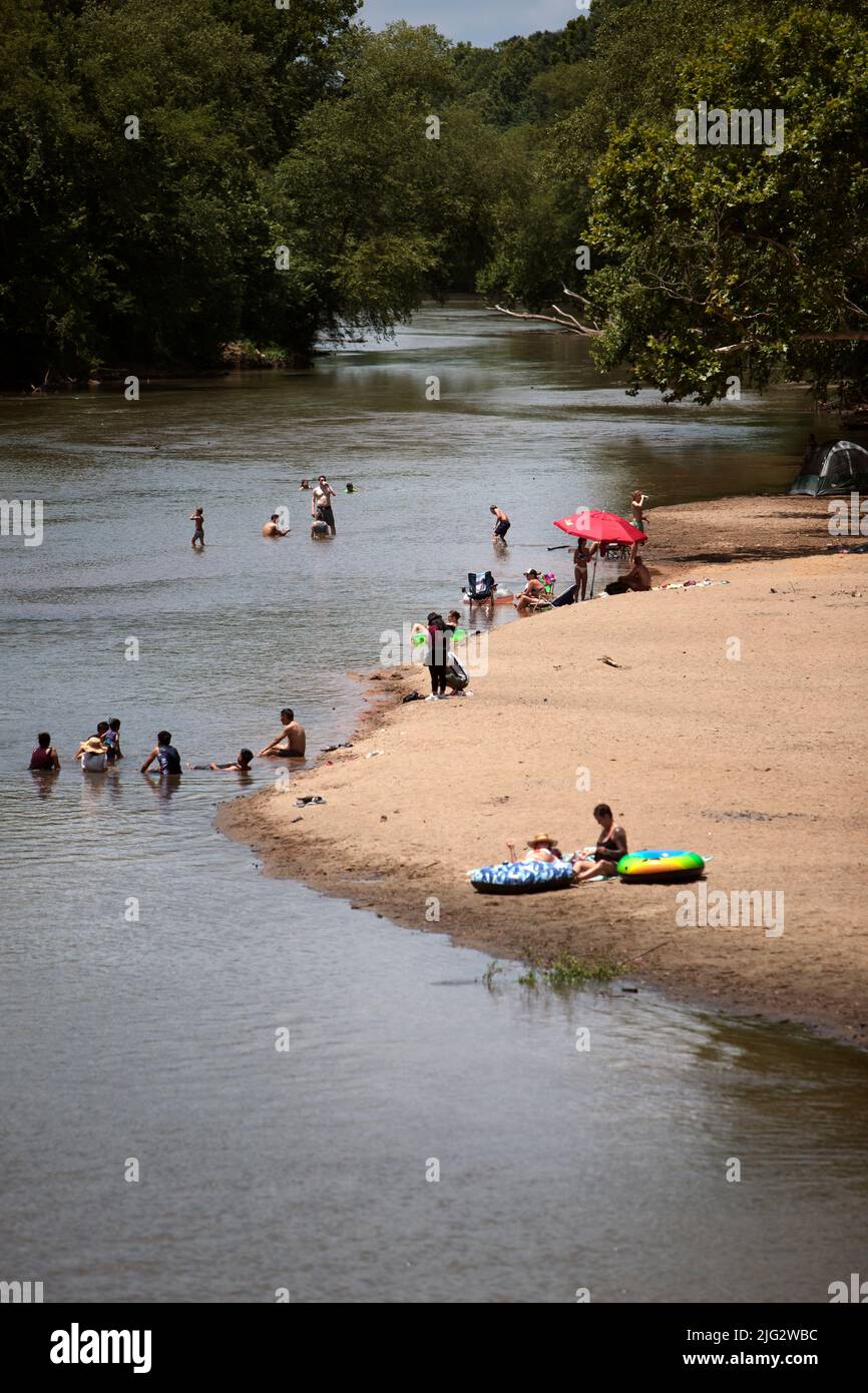 Con temperature calde e bassi livelli d'acqua, gruppi di persone nuotano nel fiume Wolf per sfuggire all'ondata di calore a Memphis, Tennessee. Su Ju Foto Stock