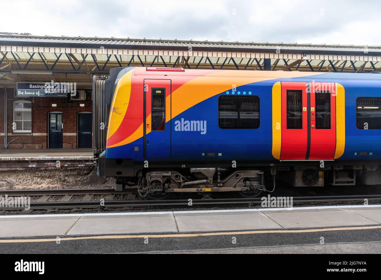 La stazione di Basingstoke con il treno della ferrovia sud occidentale ha fermato, Hampshire, Inghilterra, Regno Unito Foto Stock