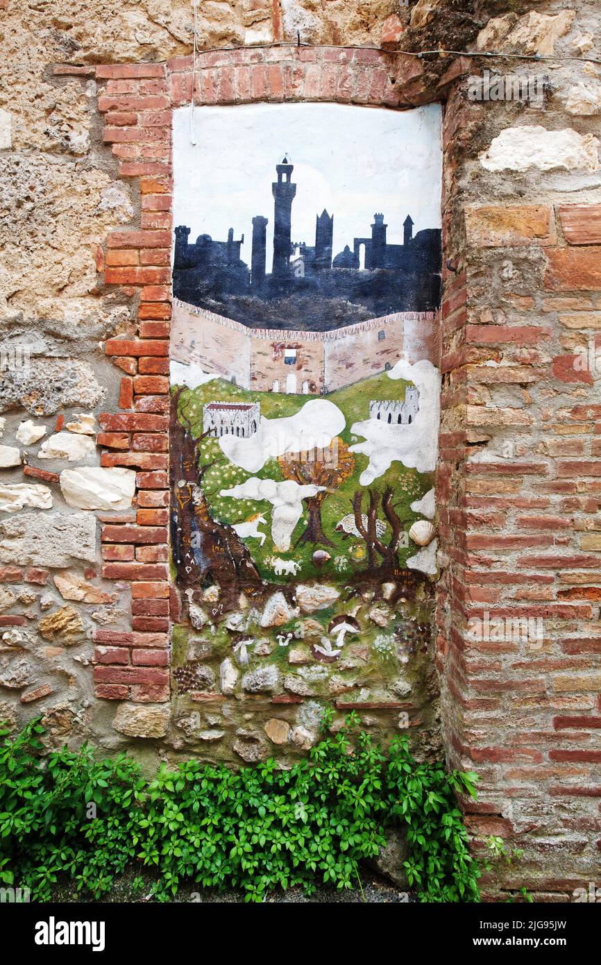 Pittura ingenua in una vecchia nicchia porta, Toscana Foto Stock