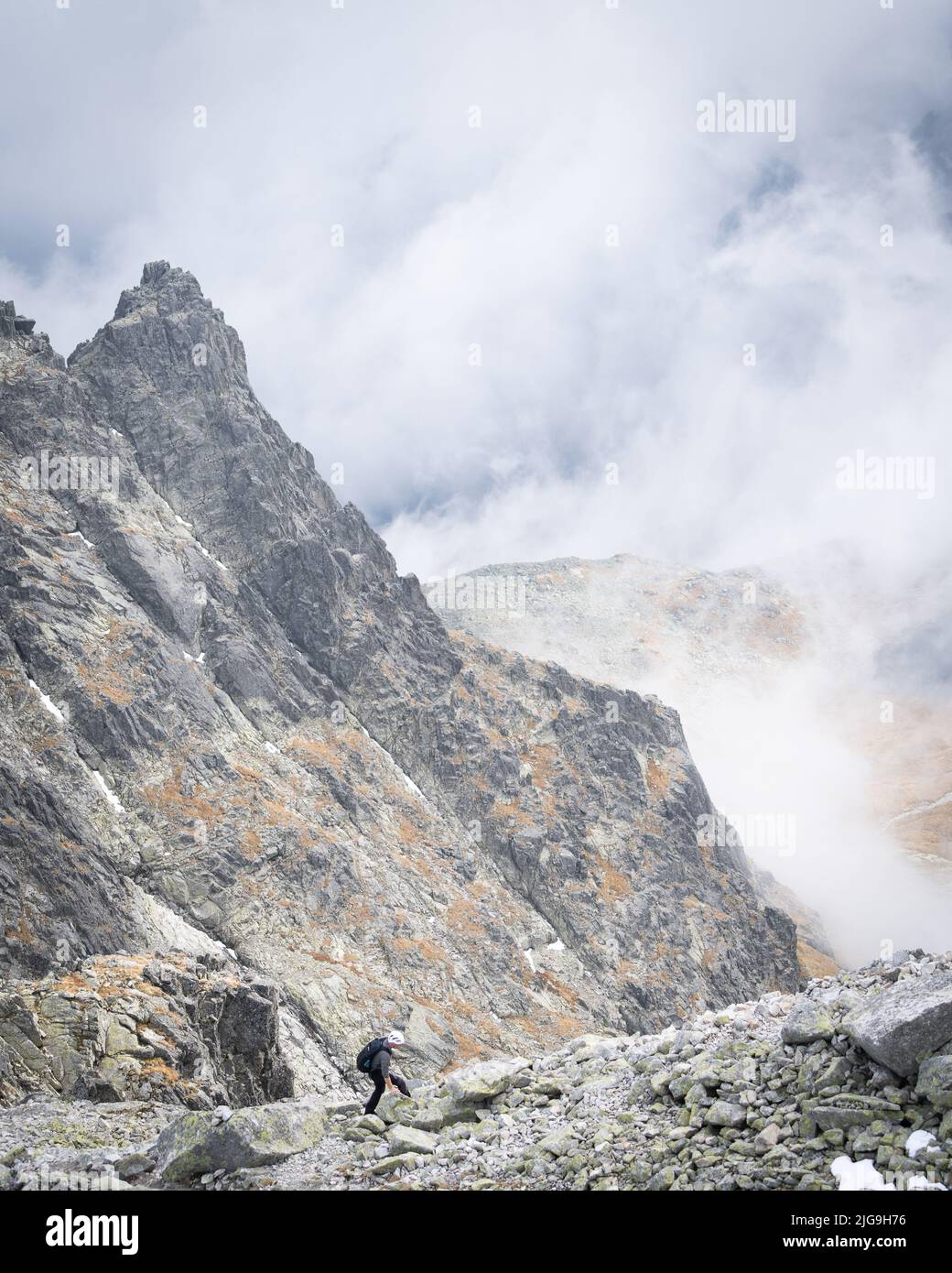 Scalatore di montagna a piedi cresta rocciosa in alto tra le nuvole , Slovacchia, Europa Foto Stock